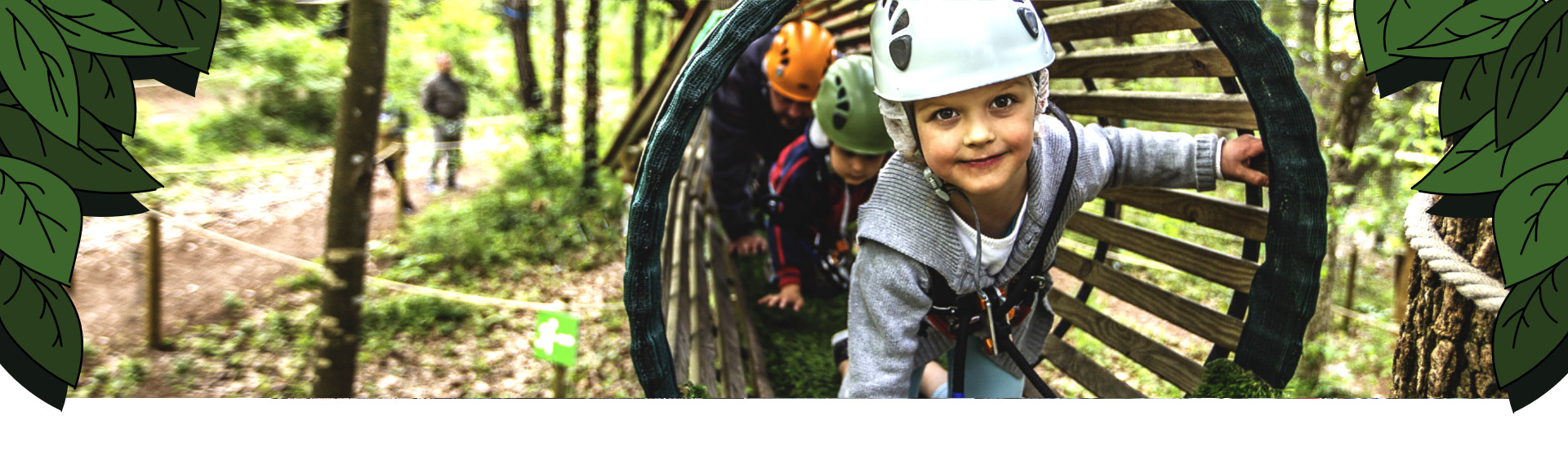 Children with helmets in a wooden tunnel in the trees
